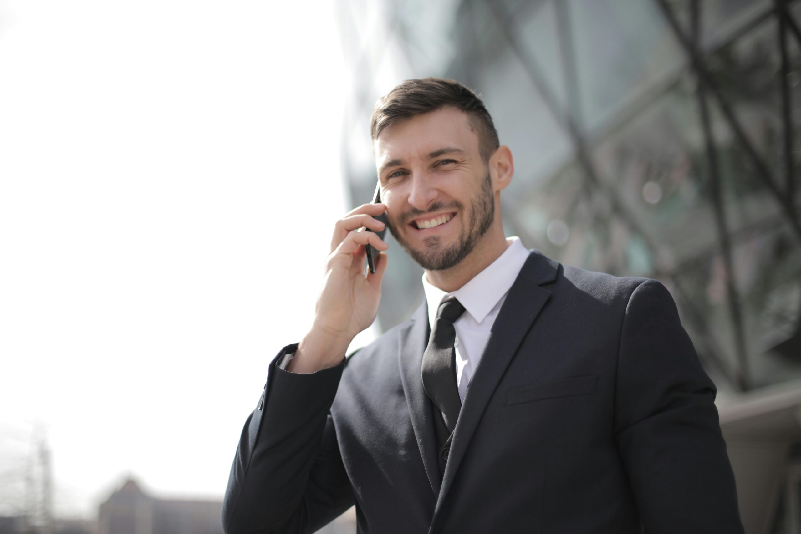 Man in a suit holding his phone.
