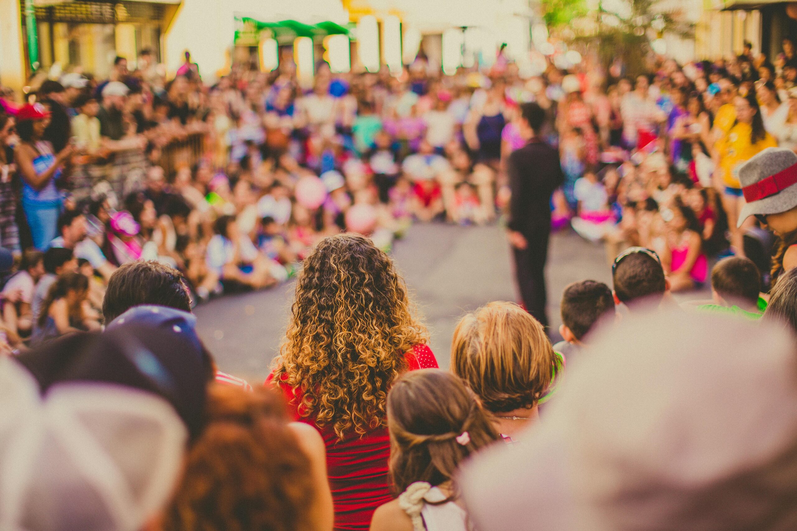 A crowd of people standing in the street.